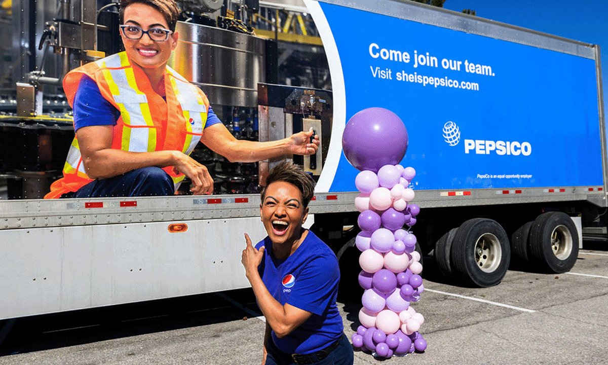 PepsiCo associate pointing to her face on a PepsiCo truck