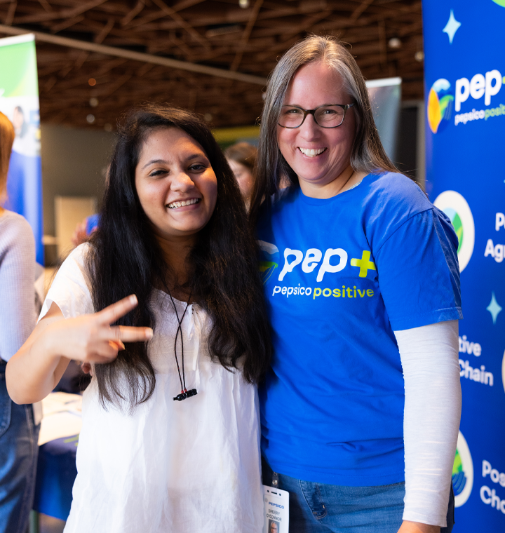 Employees at a pep+ (PepsiCo Positive) information booth